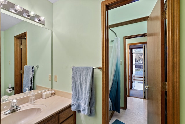 bathroom featuring vanity and curtained shower