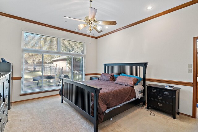 bedroom with light carpet, ceiling fan, and ornamental molding