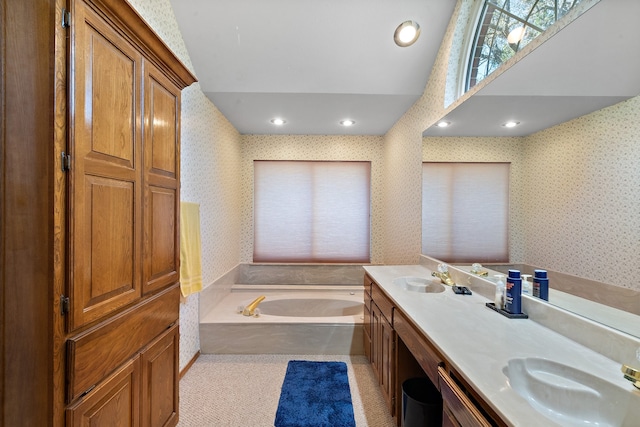 bathroom with a tub and vanity