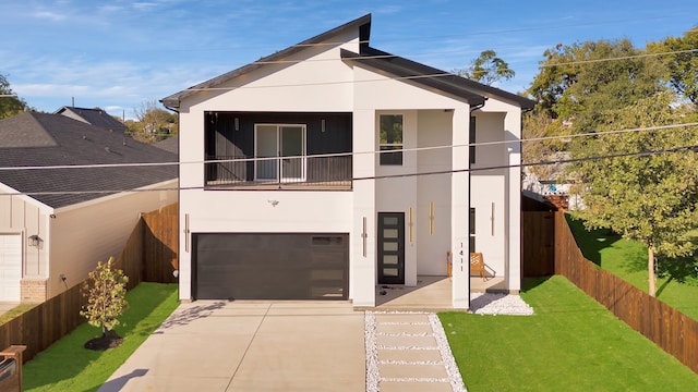 view of front of home with a front yard and a garage