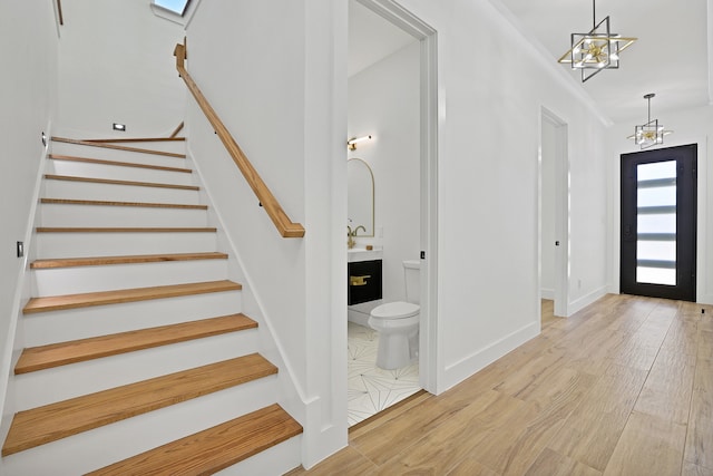 foyer featuring light hardwood / wood-style flooring and a notable chandelier