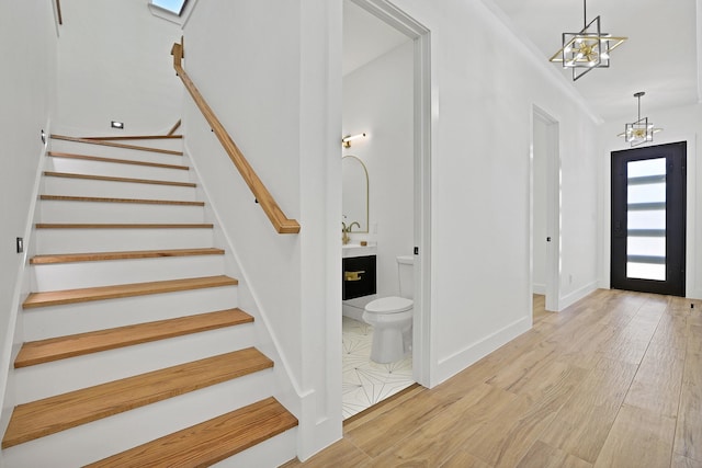 entrance foyer featuring an inviting chandelier and light wood-type flooring