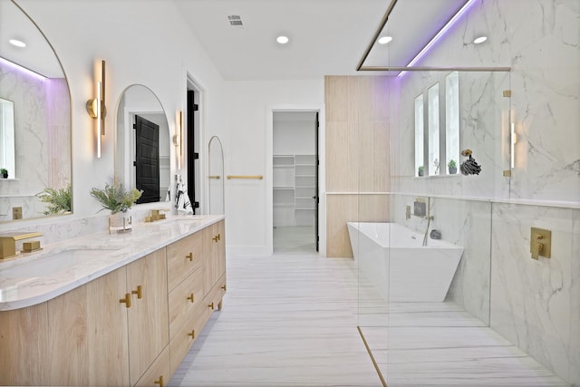 bathroom with vanity and separate shower and tub