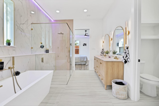 full bathroom featuring vanity, toilet, and separate shower and tub