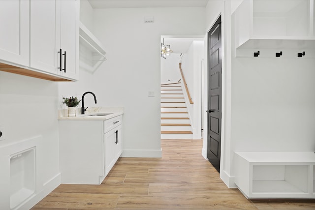 washroom featuring light wood-type flooring and sink