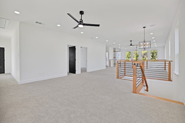 carpeted living room featuring ceiling fan with notable chandelier