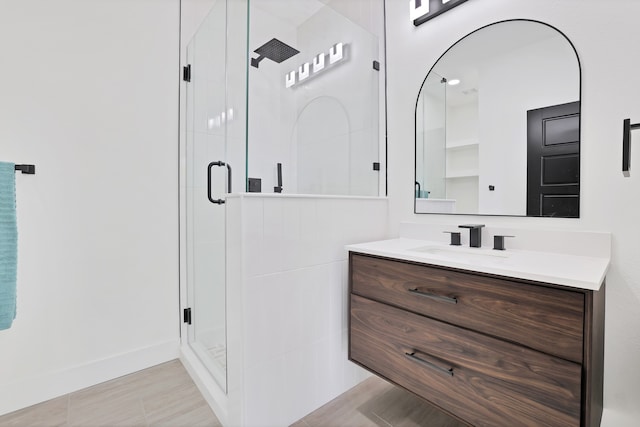 bathroom with vanity and a shower with shower door