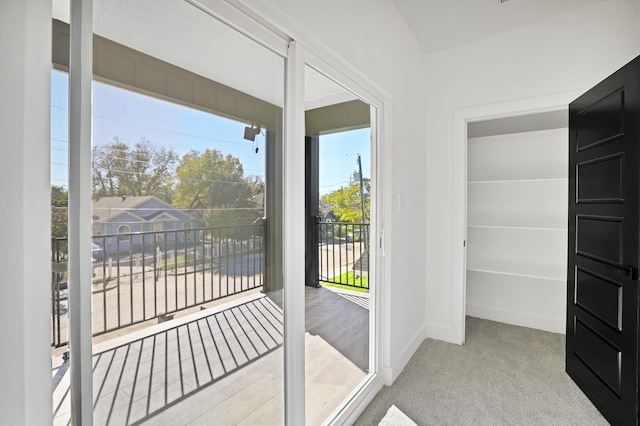 doorway featuring light carpet