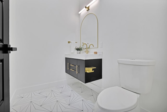 bathroom with tile patterned floors, vanity, and toilet