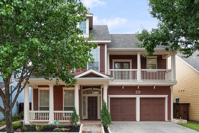 view of front of property with a balcony and a garage