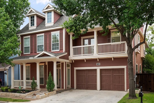 view of front of home with covered porch, a balcony, and a garage