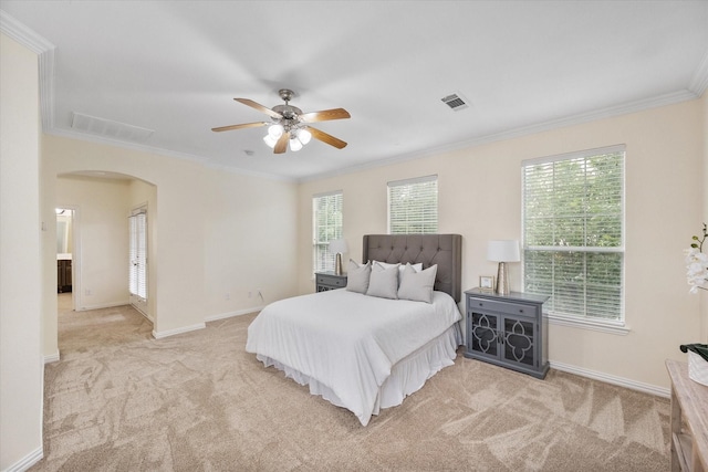 carpeted bedroom featuring ceiling fan and ornamental molding