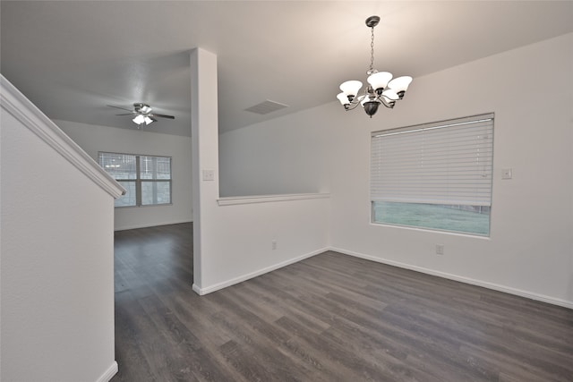 unfurnished dining area featuring dark wood-type flooring and ceiling fan with notable chandelier