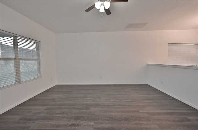 spare room with ceiling fan and dark wood-type flooring