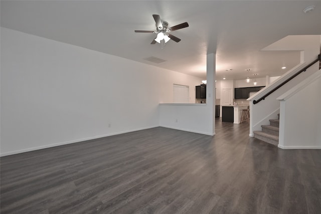 unfurnished living room featuring dark hardwood / wood-style floors and ceiling fan