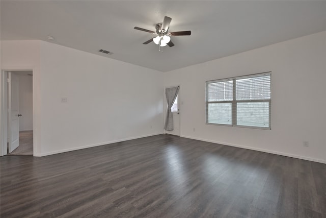 spare room featuring ceiling fan and dark wood-type flooring