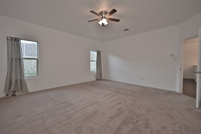 carpeted empty room featuring ceiling fan