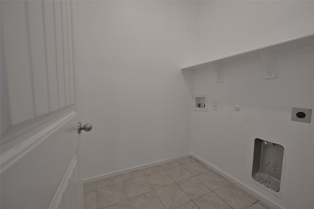 washroom with gas dryer hookup, hookup for a washing machine, light tile patterned floors, and hookup for an electric dryer