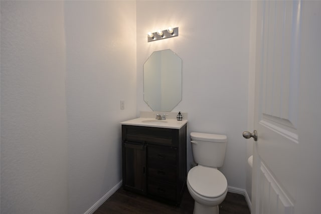 bathroom with vanity, wood-type flooring, and toilet