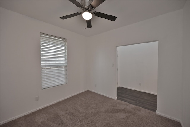 carpeted empty room featuring ceiling fan