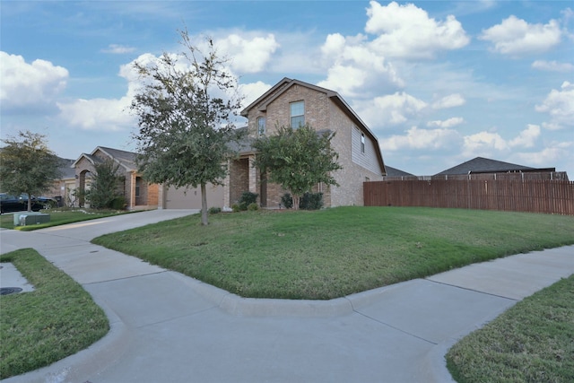 view of front of home with a front yard and a garage