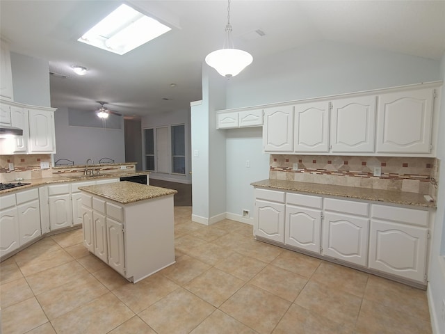 kitchen featuring white cabinetry, a center island, black gas cooktop, pendant lighting, and lofted ceiling