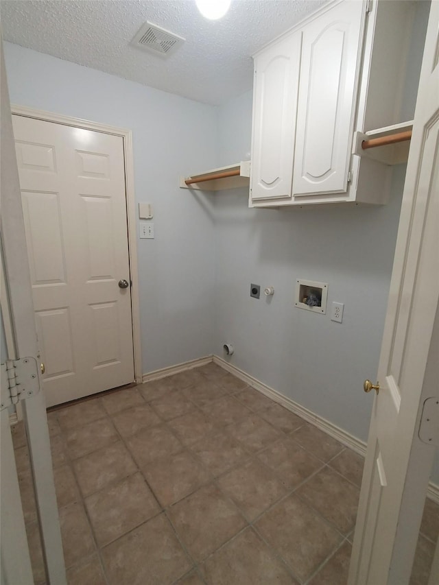 340 Thomas Dr, Murphy, TX 75094 - washroom with cabinet space, electric dryer hookup, hookup for a washing machine, gas dryer hookup, and a textured ceiling