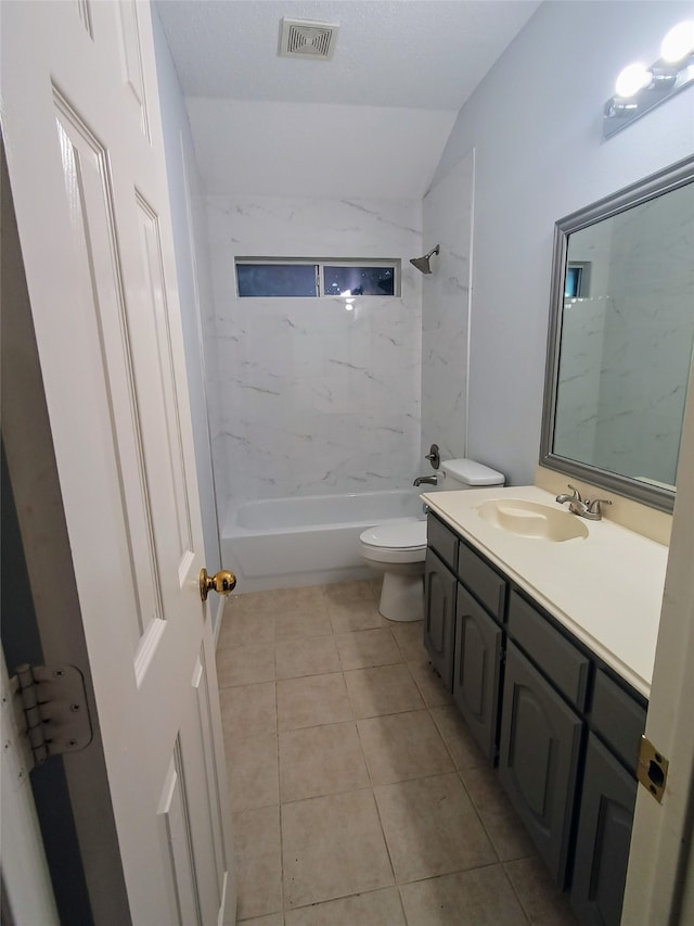 full bathroom featuring a textured ceiling, vanity, tiled shower / bath combo, tile patterned flooring, and toilet