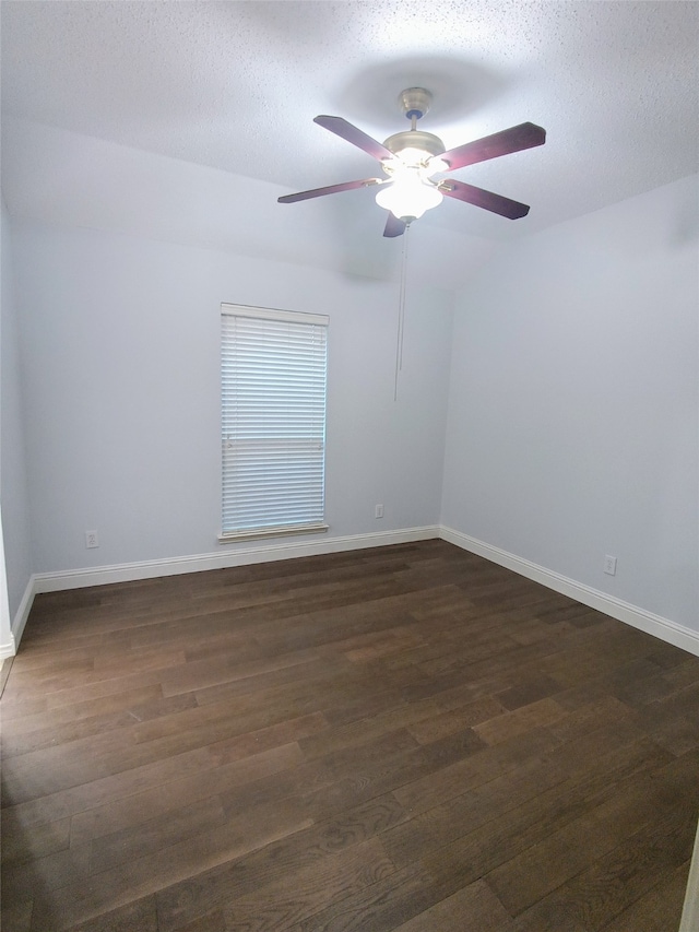 empty room featuring a textured ceiling, ceiling fan, and dark hardwood / wood-style floors