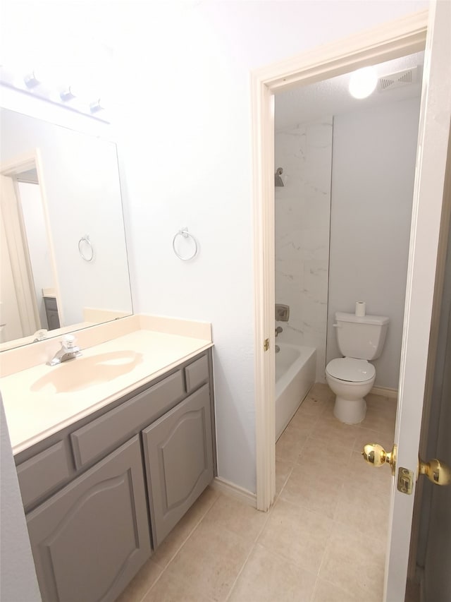 full bathroom featuring tile patterned flooring, vanity, toilet, and tiled shower / bath combo