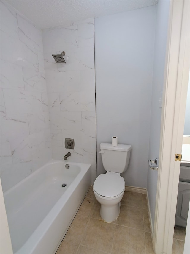 full bathroom featuring tile patterned flooring, toilet, a textured ceiling, and tiled shower / bath