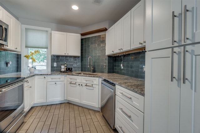 kitchen with white cabinets, sink, and appliances with stainless steel finishes