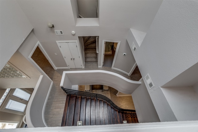 staircase featuring a high ceiling