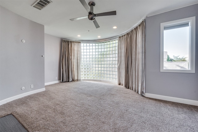 unfurnished room featuring carpet flooring, ceiling fan, and a healthy amount of sunlight