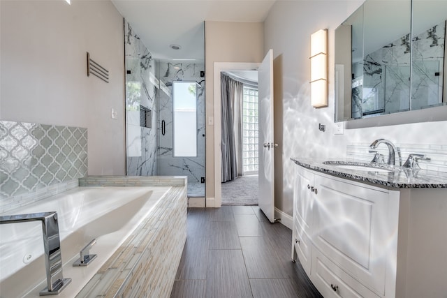 bathroom featuring vanity and shower with separate bathtub