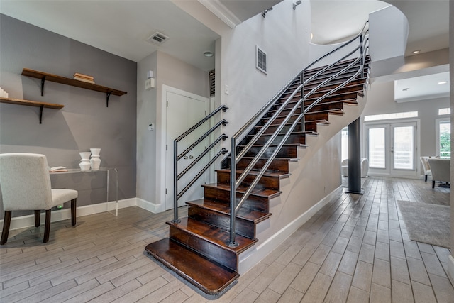 staircase featuring french doors and wood-type flooring