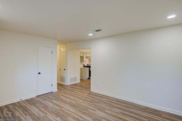 spare room featuring light hardwood / wood-style floors