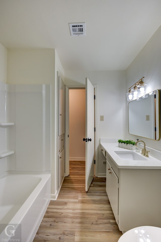 bathroom with vanity, shower / bathtub combination, and hardwood / wood-style flooring