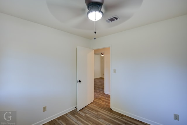 unfurnished room with hardwood / wood-style floors and ceiling fan