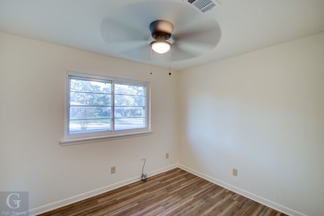 empty room with ceiling fan and hardwood / wood-style flooring