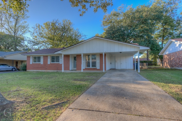 ranch-style house featuring a front yard, a carport, and covered porch