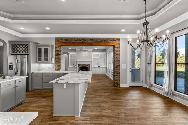 kitchen with gray cabinets, dark hardwood / wood-style flooring, and crown molding