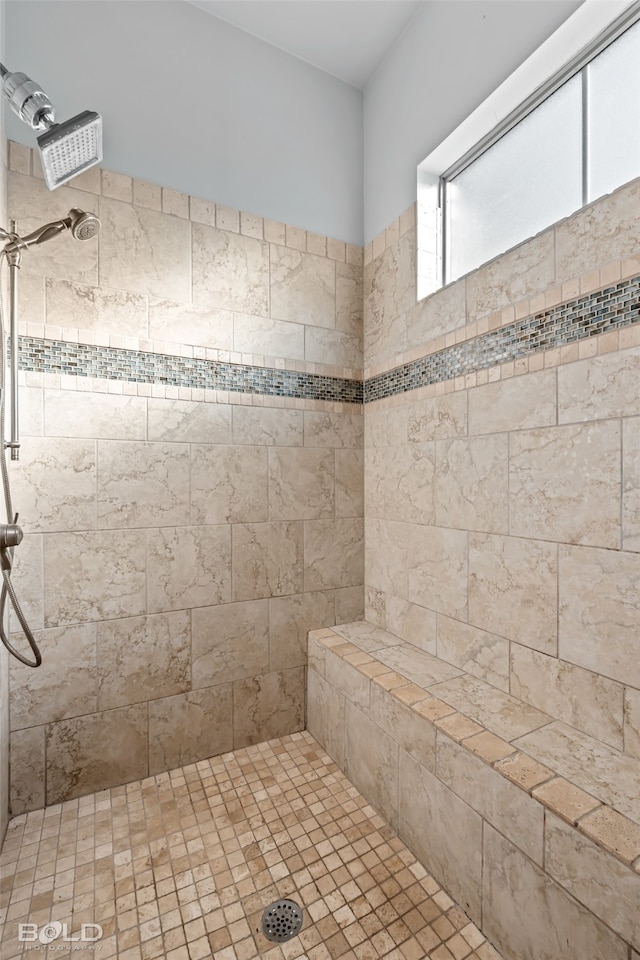 bathroom with tiled shower