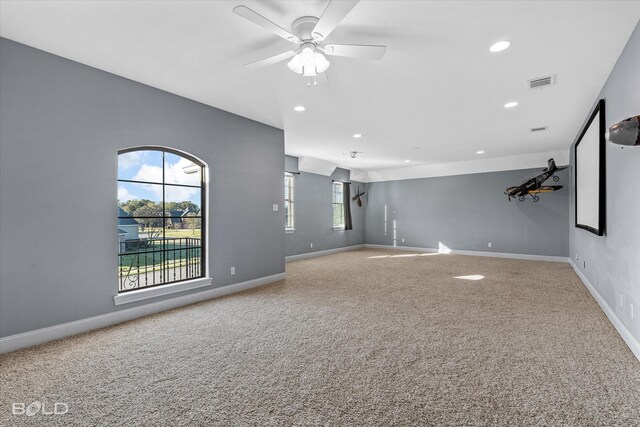 unfurnished living room with carpet floors, ceiling fan, and a healthy amount of sunlight