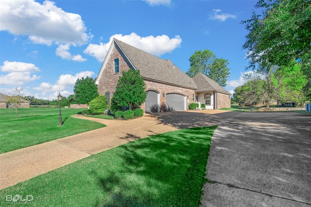 view of front of property with a front yard and a garage