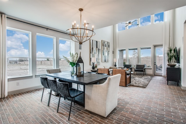 dining room with ceiling fan with notable chandelier