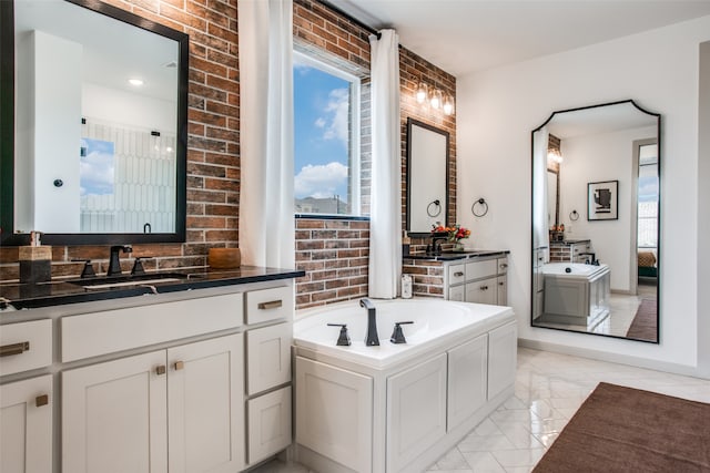 bathroom with vanity, a bathing tub, and brick wall