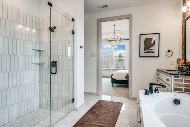 bathroom with a chandelier, vanity, and independent shower and bath