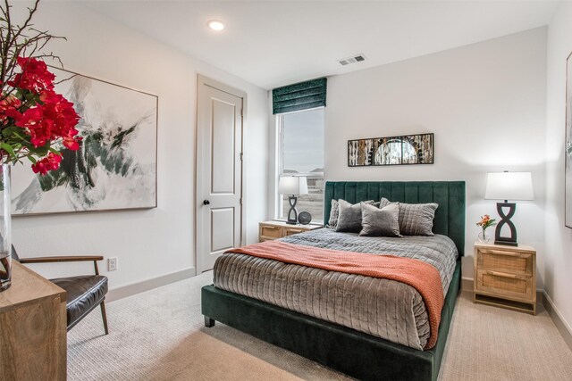 bedroom featuring light colored carpet