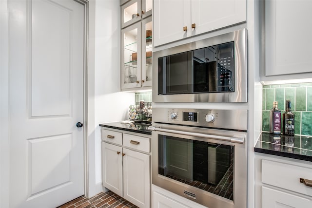 kitchen with white cabinetry, appliances with stainless steel finishes, and tasteful backsplash